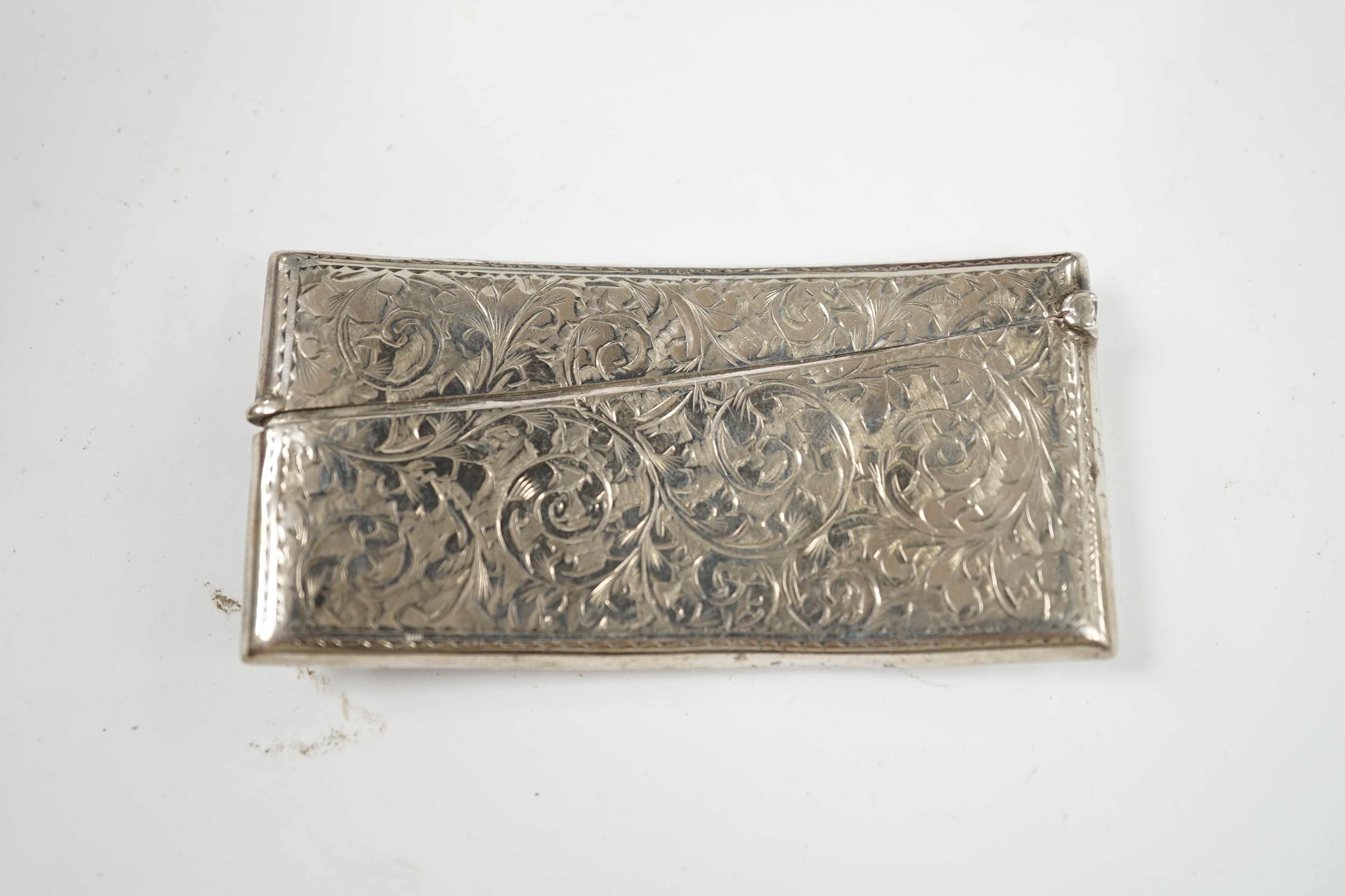 An Edwardian engraved silver card case, Birmingham, 1907, 82mm and a modern silver desk timepiece. Condition - poor to fair